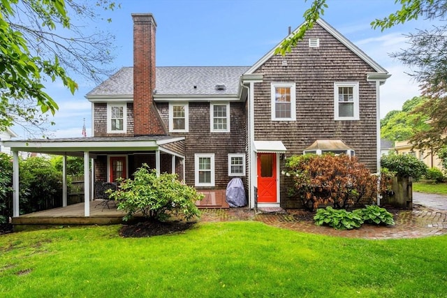 9 Palmer Rd, Marblehead, MA 01945 - back of property featuring a lawn, a chimney, and a shingled roof