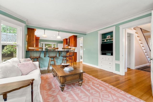 9 Palmer Rd, Marblehead, MA 01945 - living area with healthy amount of natural light, light wood-style flooring, baseboards, ornamental molding, and stairway