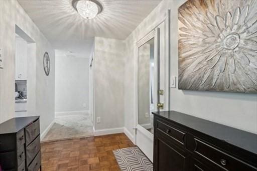 corridor with dark parquet flooring