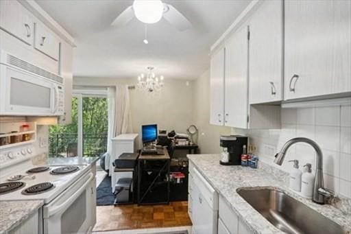 kitchen with white cabinetry, white appliances, dark parquet flooring, and sink