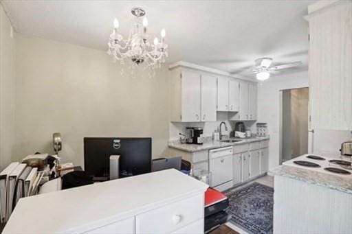 kitchen featuring ceiling fan with notable chandelier, pendant lighting, dishwasher, sink, and white cabinets