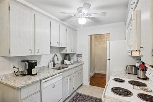 kitchen featuring ceiling fan, white appliances, sink, and white cabinets