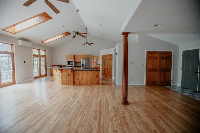 251 Butterworth Rd, Barre, MA 01005 - kitchen featuring a ceiling fan, open floor plan, an AC wall unit, stainless steel appliances, and light wood-style flooring