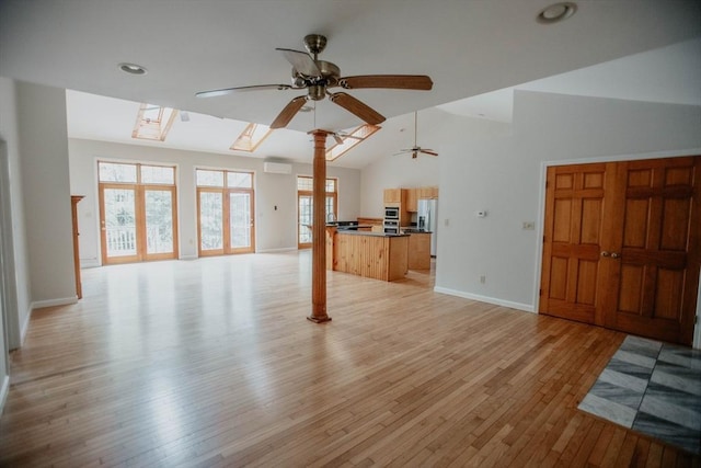 251 Butterworth Rd, Barre, MA 01005 - unfurnished living room with ceiling fan, light wood-type flooring, lofted ceiling, a skylight, and recessed lighting