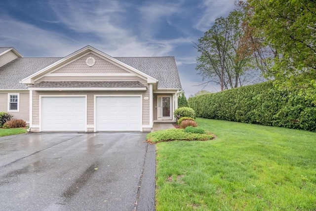 view of front of house featuring driveway, a garage, a front yard, and roof with shingles