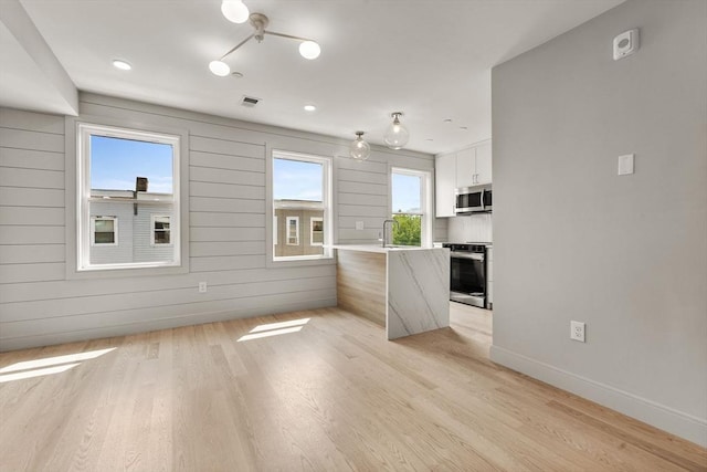 88 Maverick St Unit 3, Boston, MA 02128 - unfurnished living room featuring light wood-style floors and recessed lighting