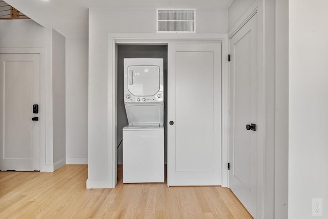 88 Maverick St Unit 3, Boston, MA 02128 - laundry room featuring stacked washer / drying machine and light wood-style floors
