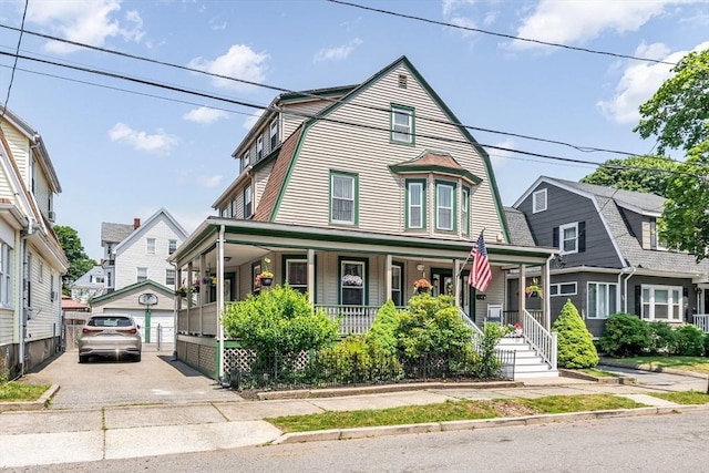 16 Pacific St, Lynn, MA 01902 - view of front facade featuring covered porch, a gambrel roof, an outdoor structure, and a garage