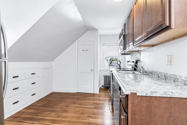16 Pacific St, Lynn, MA 01902 - kitchen with radiator, dark wood-style flooring, lofted ceiling, and stainless steel microwave