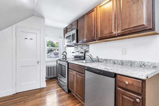 16 Pacific St, Lynn, MA 01902 - kitchen with appliances with stainless steel finishes, radiator, wood finished floors, and vaulted ceiling