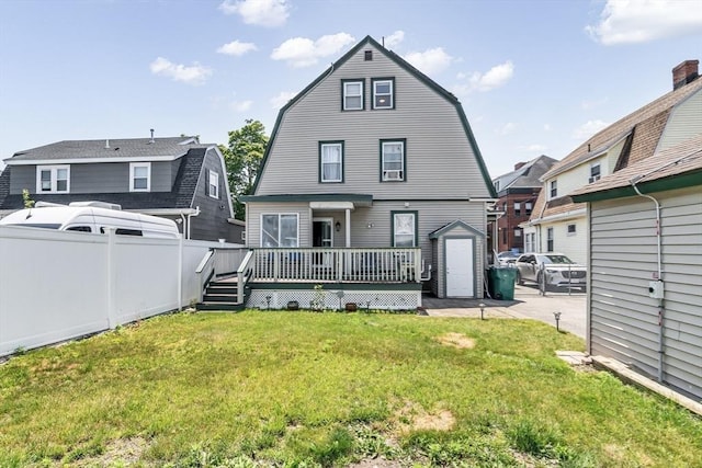16 Pacific St, Lynn, MA 01902 - back of house with a gambrel roof, a wooden deck, and a storage shed