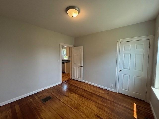 404 Brayton Ave, Fall River, MA 02721 - unfurnished bedroom with wood finished floors and baseboards