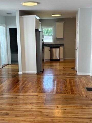 404 Brayton Ave, Fall River, MA 02721 - kitchen featuring appliances with stainless steel finishes, white cabinetry, and wood finished floors