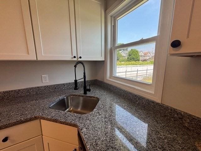 404 Brayton Ave, Fall River, MA 02721 - kitchen featuring white cabinetry and dark stone counters