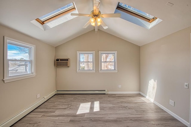 unfurnished room with vaulted ceiling with skylight, a baseboard radiator, baseboard heating, a wall mounted AC, and light wood finished floors