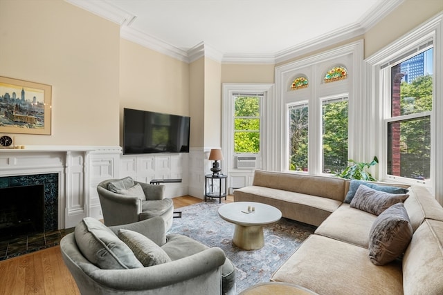 living room with cooling unit, a premium fireplace, hardwood / wood-style flooring, and crown molding