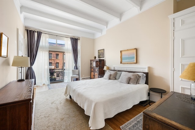 bedroom featuring access to exterior, hardwood / wood-style flooring, a baseboard radiator, and beam ceiling