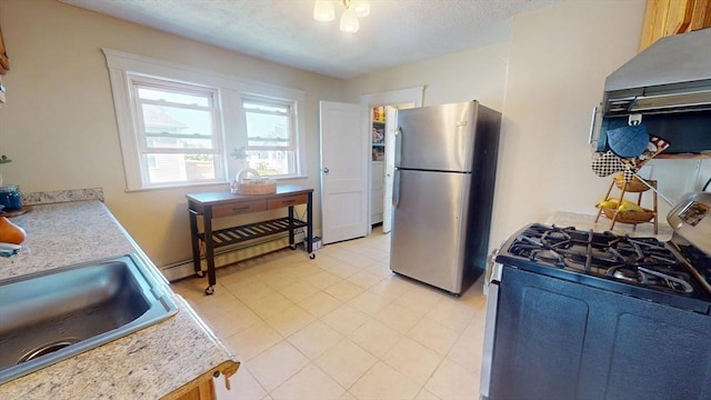 31-33 Harvard St, Medford, MA 02155 - kitchen featuring gas stove, freestanding refrigerator, under cabinet range hood, light countertops, and light tile patterned floors