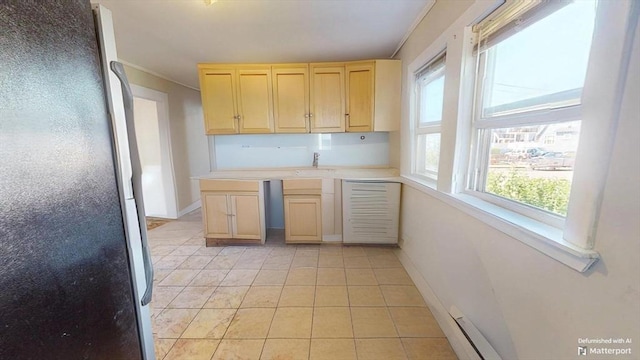 31-33 Harvard St, Medford, MA 02155 - kitchen featuring freestanding refrigerator, light brown cabinetry, light countertops, light tile patterned flooring, and ornamental molding