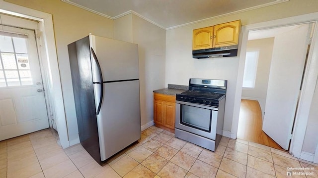 31-33 Harvard St, Medford, MA 02155 - kitchen with stainless steel appliances, under cabinet range hood, crown molding, and dark countertops