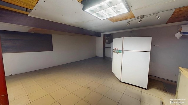 31-33 Harvard St, Medford, MA 02155 - finished below grade area featuring freestanding refrigerator and light tile patterned floors