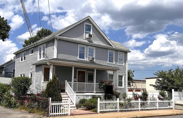 31-33 Harvard St, Medford, MA 02155 - view of front of home featuring a porch, cooling unit, and a fenced front yard