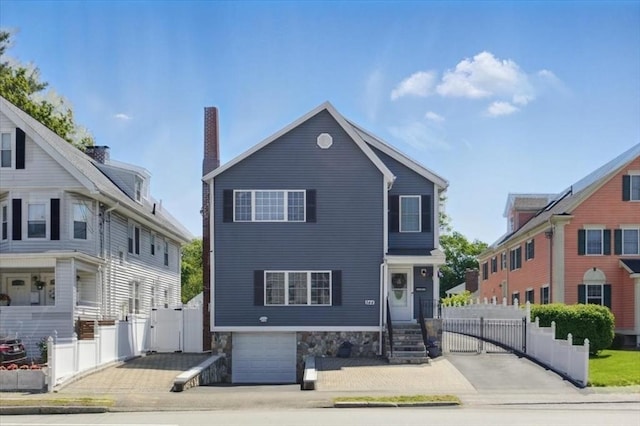 544 Main St, Stoneham, MA 02180 - view of front of property with a gate and a garage