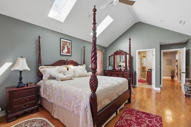 544 Main St, Stoneham, MA 02180 - bedroom with a skylight, light wood-style flooring, vaulted ceiling, ensuite bath, and ceiling fan