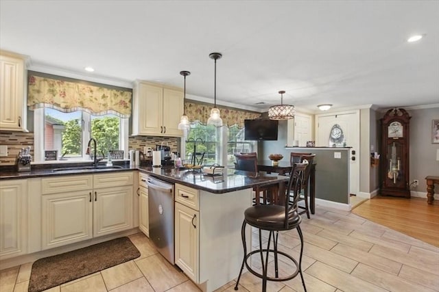 544 Main St, Stoneham, MA 02180 - kitchen featuring stainless steel dishwasher, a sink, cream cabinets, a peninsula, and ornamental molding