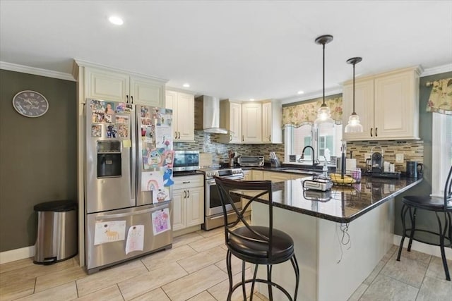 544 Main St, Stoneham, MA 02180 - kitchen featuring stainless steel appliances, wall chimney range hood, a sink, a peninsula, and a breakfast bar