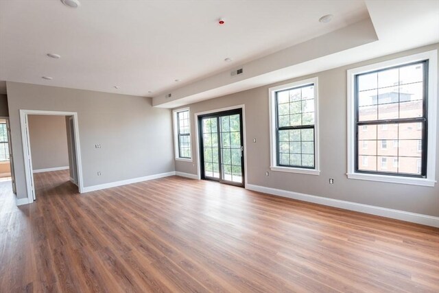 unfurnished room with hardwood / wood-style flooring