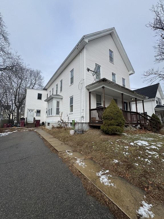 view of side of property with a porch