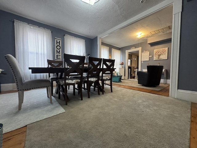 dining room featuring a textured ceiling and carpet floors