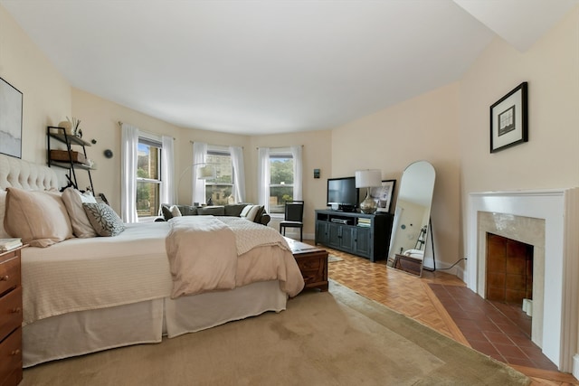 bedroom featuring a premium fireplace and parquet floors