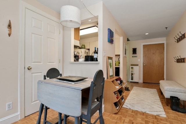 dining room featuring beverage cooler and light parquet floors