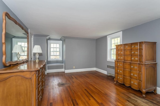 interior space with radiator heating unit, dark wood-type flooring, and baseboards