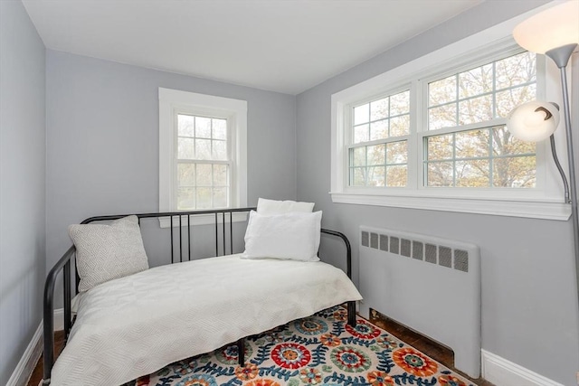 bedroom featuring radiator heating unit and baseboards