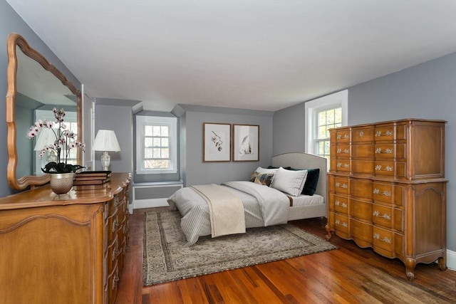 bedroom with wood finished floors and baseboards