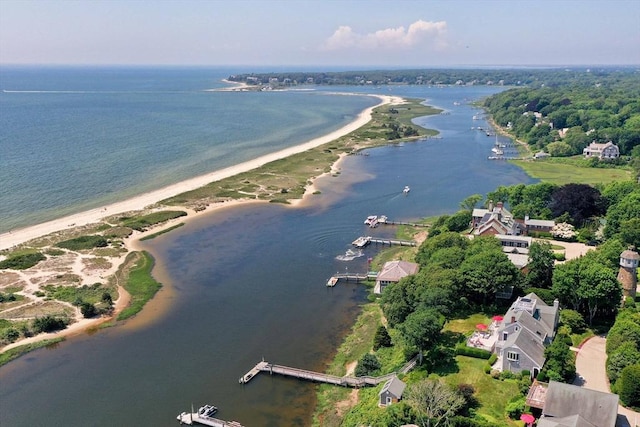 aerial view with a water view and a beach view