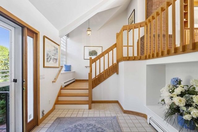 staircase with plenty of natural light, baseboard heating, and lofted ceiling