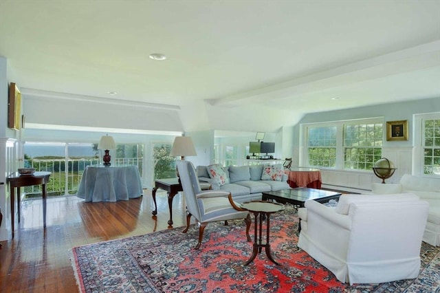 living room featuring wood-type flooring, baseboard heating, and lofted ceiling with beams