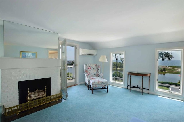 sitting room featuring vaulted ceiling, a water view, carpet, a fireplace, and a wall mounted AC