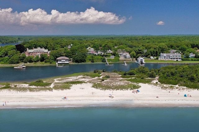 bird's eye view with a water view and a beach view