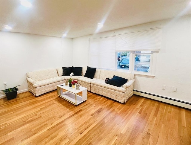 living room featuring a baseboard heating unit, recessed lighting, and wood finished floors