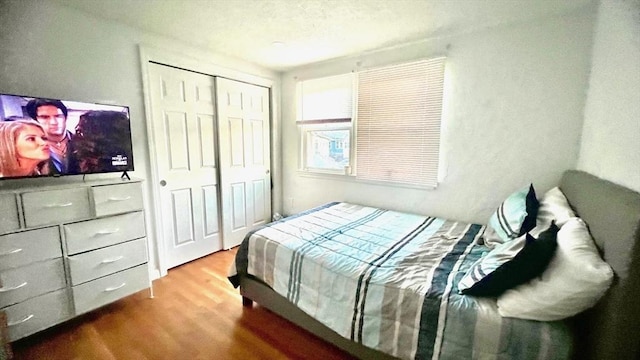 bedroom with a closet and wood finished floors