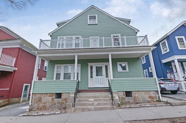 view of front of property featuring a balcony and a porch