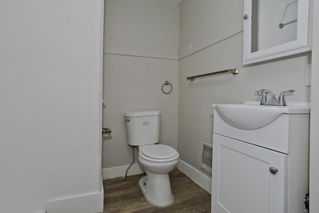 bathroom with vanity, hardwood / wood-style flooring, and toilet