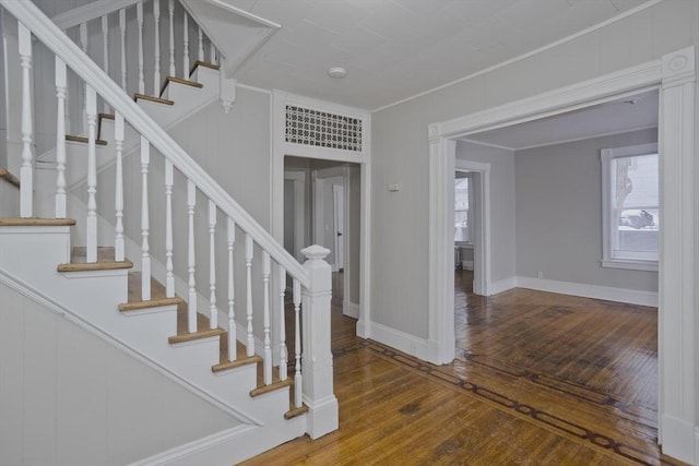 stairway featuring hardwood / wood-style flooring and crown molding