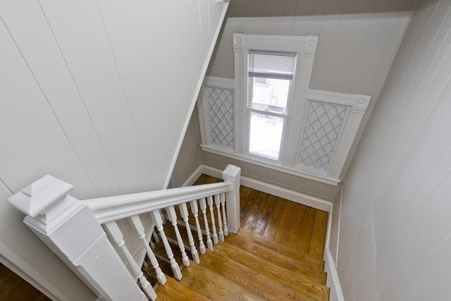 stairway with hardwood / wood-style floors