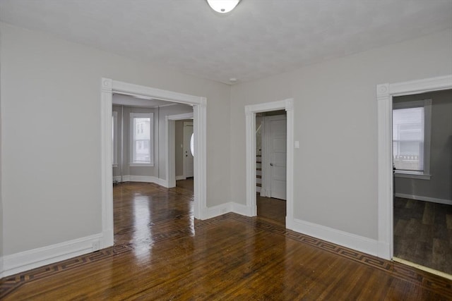 unfurnished room featuring dark wood-type flooring